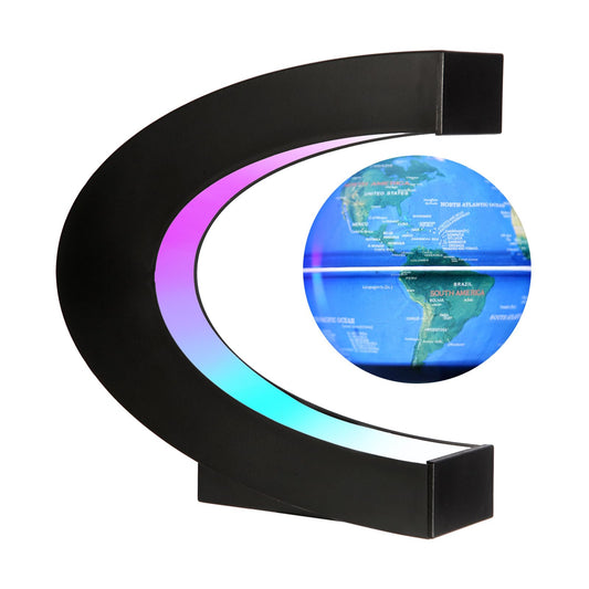 Gresus floating globe with C-shaped base levitates on a desk