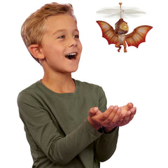 GrossMos Flying Dino orange hands-guide shows hands-on control during tall, high flights.