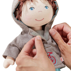 Soft 12-inch doll with quilted body sits upright for easy display.