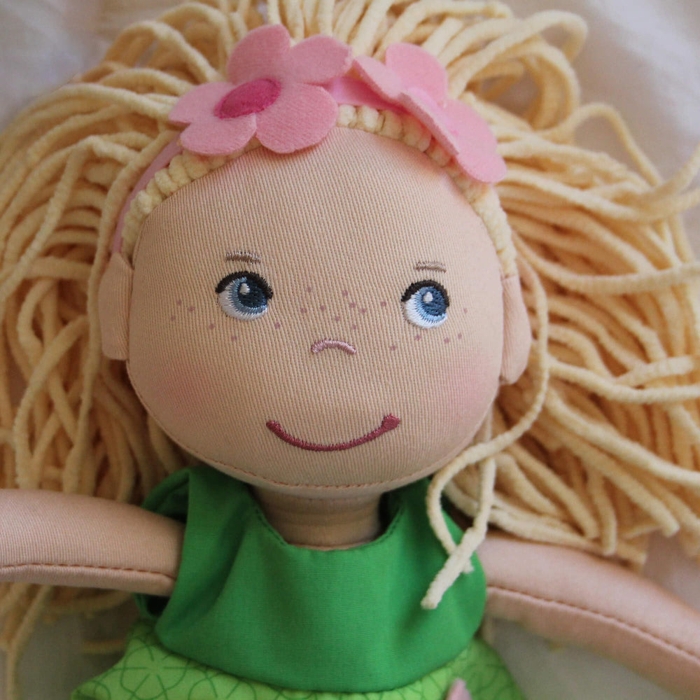 Mali doll wearing a removable green dress with leggings and accessories for mix-and-match pretend play.