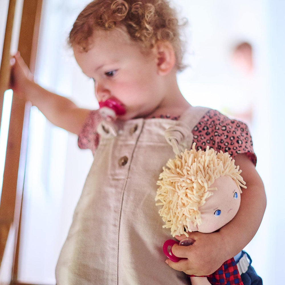 HABA Nick doll wearing jeans and plaid shirt, ready for play.