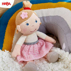 HABA Snug Up Lauren in pink skirt and white tee ready for imaginative play.