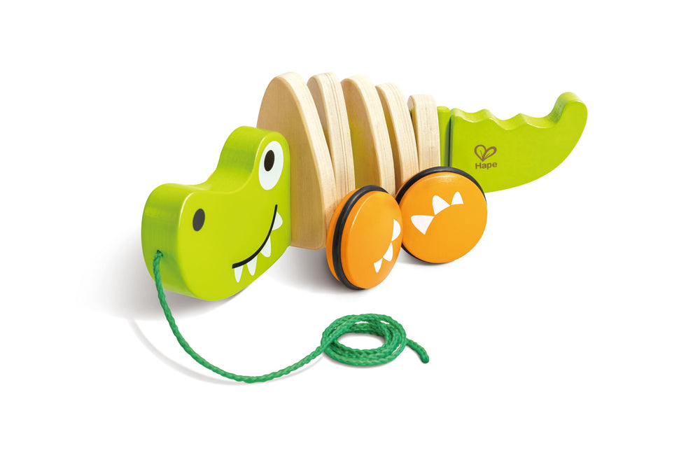 Hape Walkalong Croc pull toy with rubber wheels for smooth floor glides.