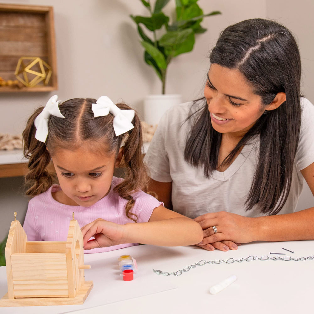 Hapinest family craft session painting and decorating a birdhouse together.