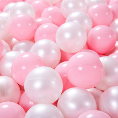 Child playing with Heopeis pink pearl white balls in a ball pit