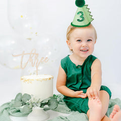 HODIHIWI dinosaur hat green side view, designed with an adjustable elastic for secure wear.