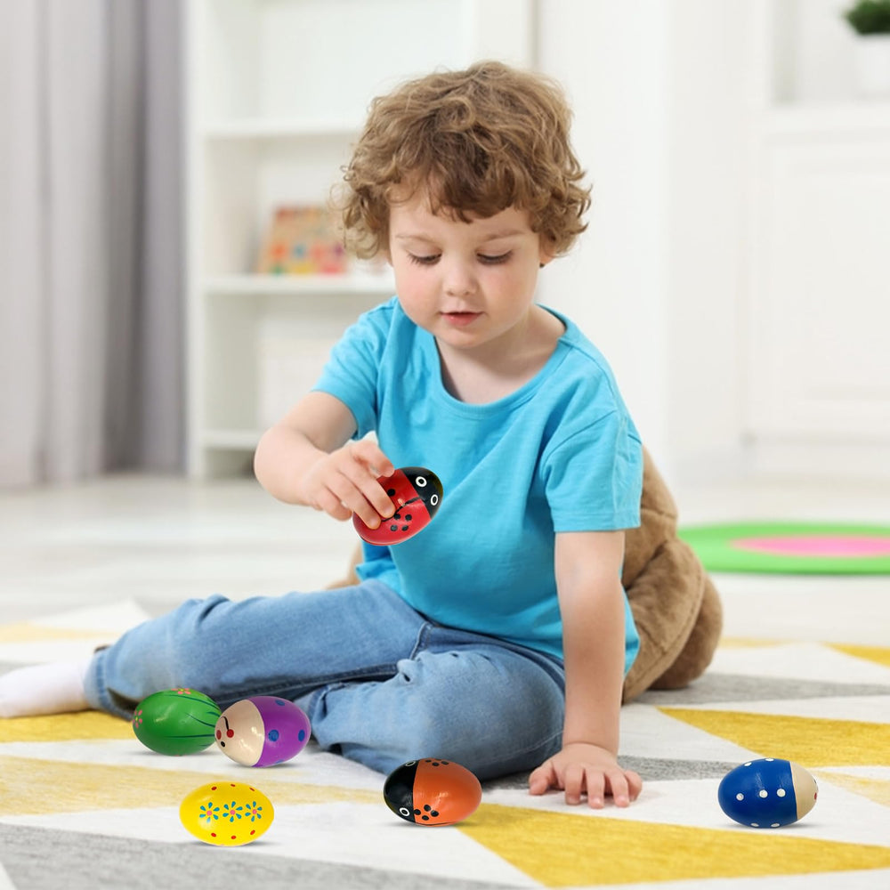 Homily wooden egg shaker with orange sunburst sparks imaginative music time.