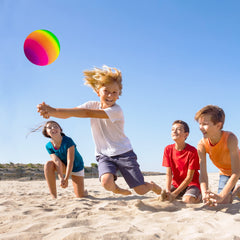 Kids inflating and playing with Homotte rainbow balls; promotes active outdoor time.