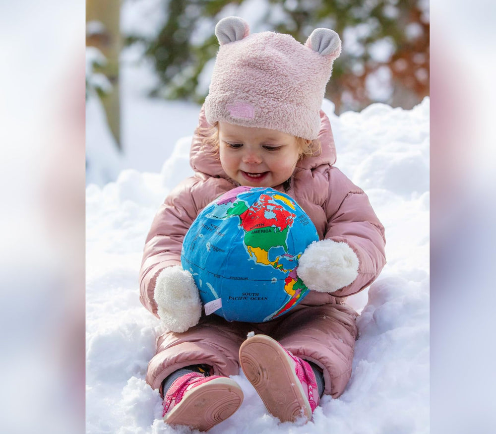 Hugg-A-Planet Baby Earth by the bed, ideal bedtime companion.