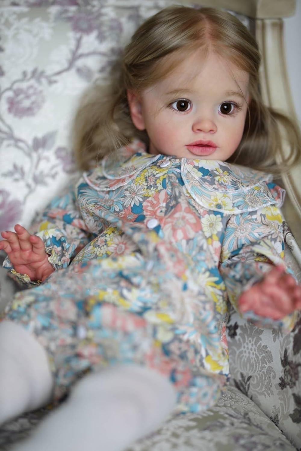 iCradle reborn toddler girl features detailed brown hair and lashes for realism.