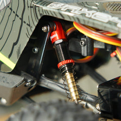 INJORA RC crawler AX24 in action with red shocks during a test run.