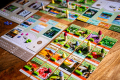 Inside Up Games Earth: Abundance event card sparks resource flow.