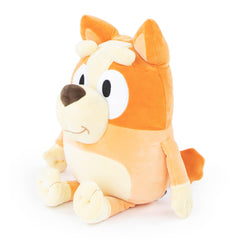 Child hugs Jay Franco Bluey Bingo pillow buddy during playtime