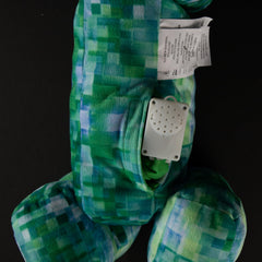 Creeper pillow resting on a bed, ideal for bedtime comfort