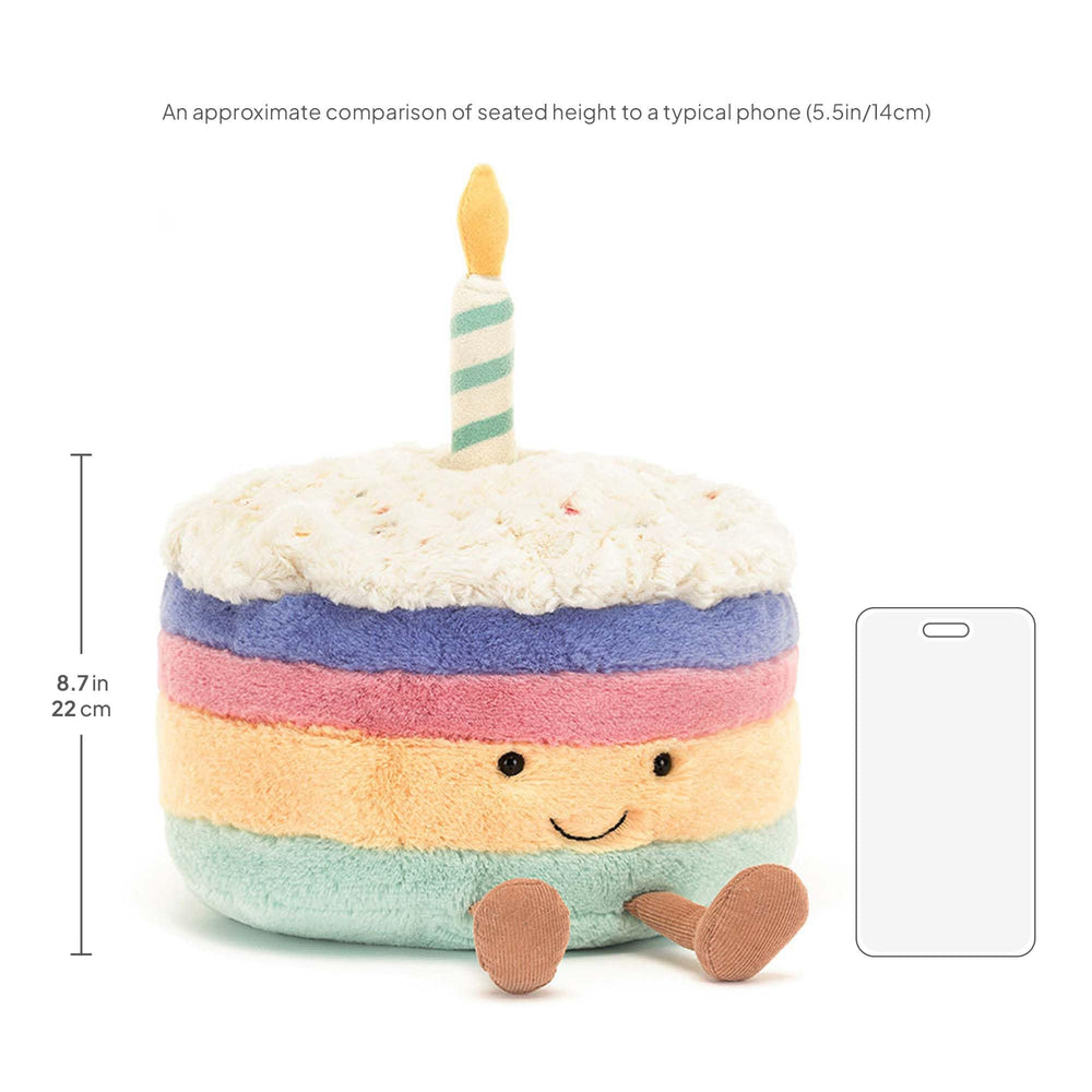 Jellycat Rainbow Birthday Cake plush held in arms, ideal for gifting and cuddles.
