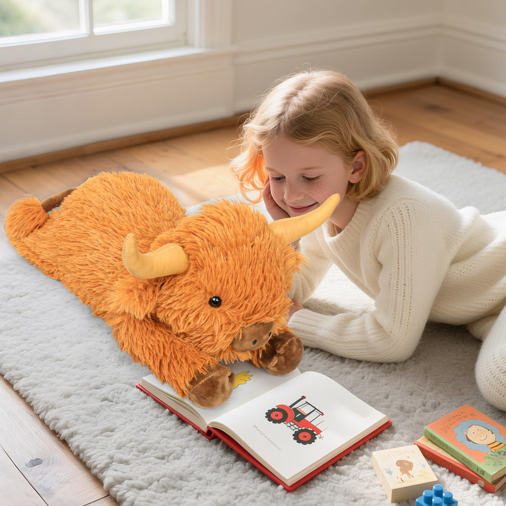 Reading cuddle setup with JellyMallow Highland Cow plush beside a book