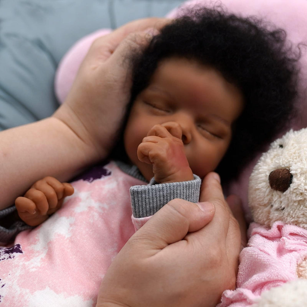 JIZHI reborn doll newborn-size outfits ready for easy dressing.