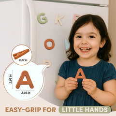 Child holds JoyCat magnetic letter while building words on metal surface.