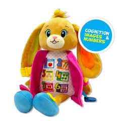 June Garden Dressy Friends Bunnie during dressing practice with buckles and zipper buttons.