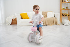 Close-up of pink KidRoller balance bike front angle showing safety features.