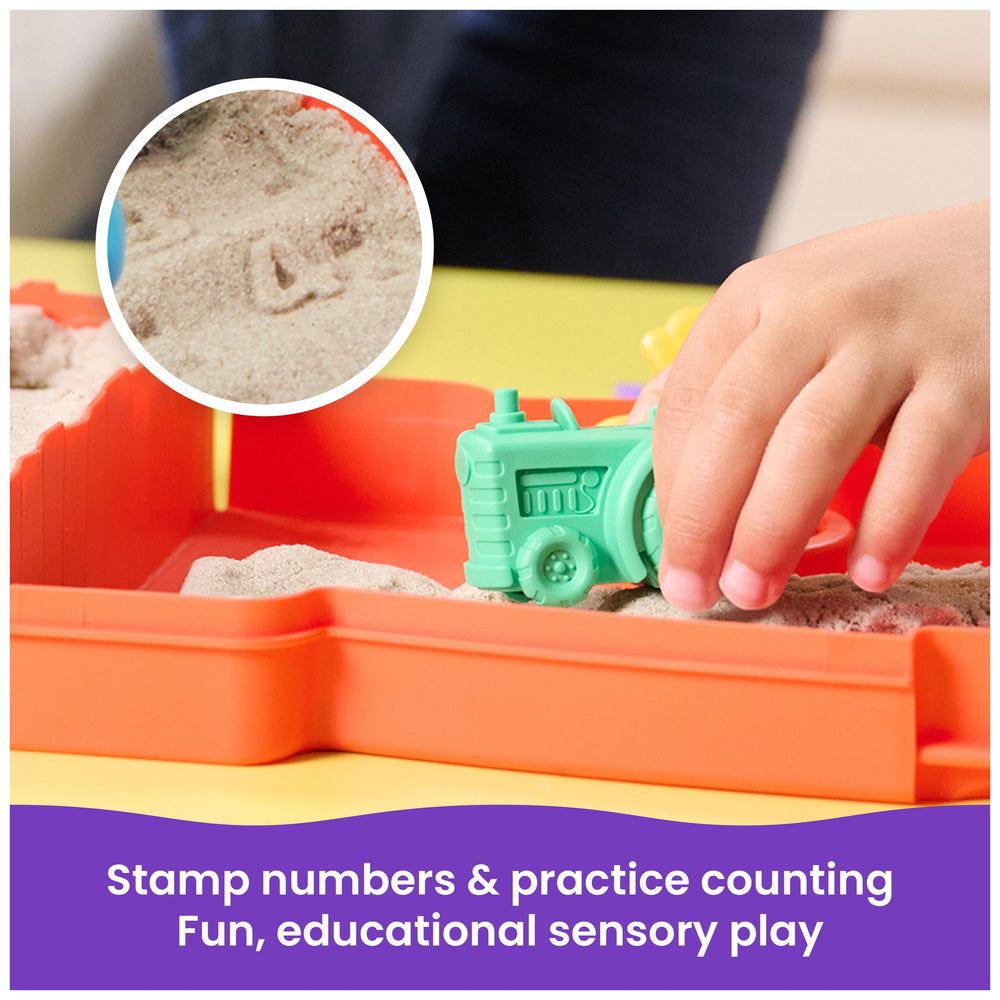 Kinetic Sand tractor rolling numbers in sand to practice counting