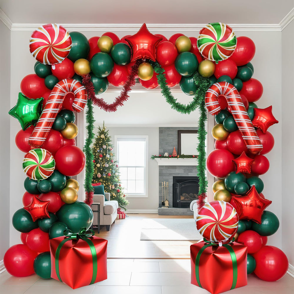 Kozee red-green-gold balloon arch creates a festive photo backdrop.