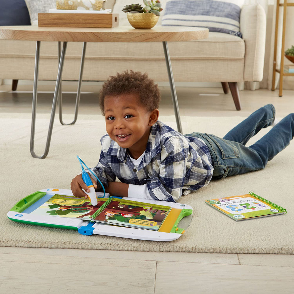 Child taps LeapStart page to explore reading and math concepts.