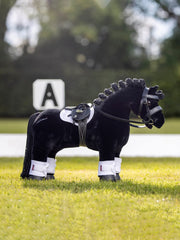 LeMieux Toy Pony Saddle showing detachable girth and metal stirrups for tacking practice