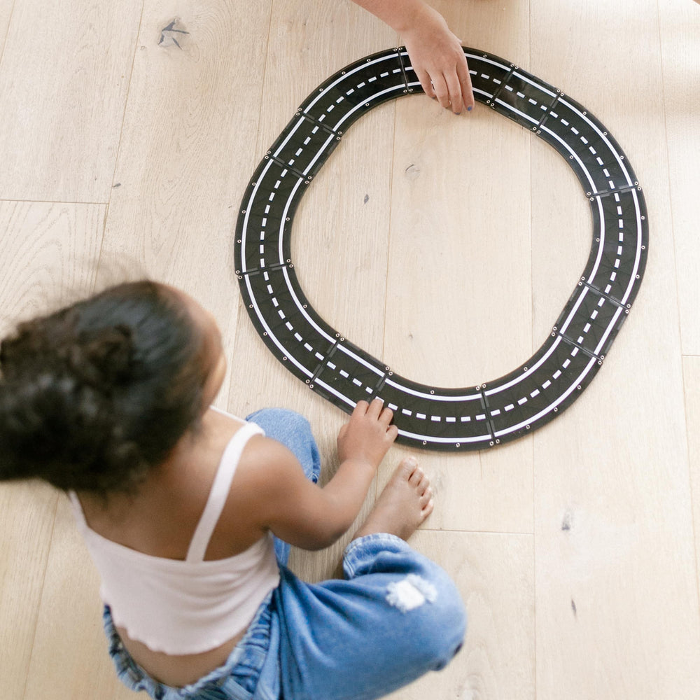 Highway and racetrack build with MAGNA-TILES XTRAS Roads connect magnets securely.