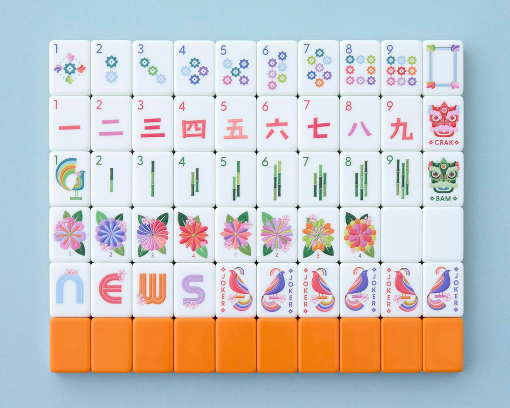 Paradise tiles by Mahjong Co. in front view show cosmic orange back and crisp artistry.