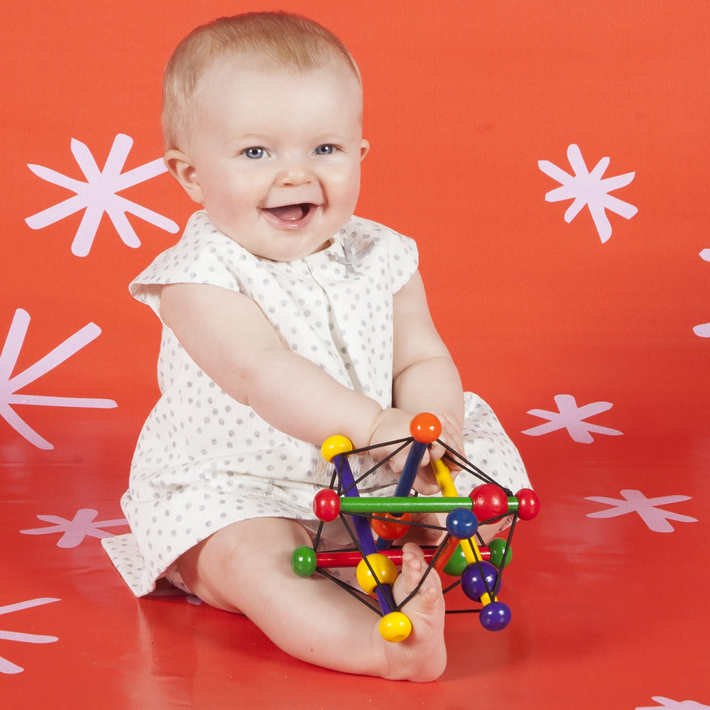 Manhattan Toy Skwish Classic 6 inch baby hands enjoy engaging playtime and fine motor practice.