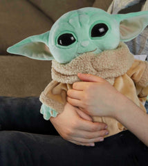 Mattel Grogu plush close-up face highlights green skin and large eyes
