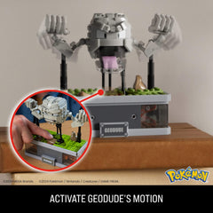 Geodude hidden button activates punching motion for interactive display.