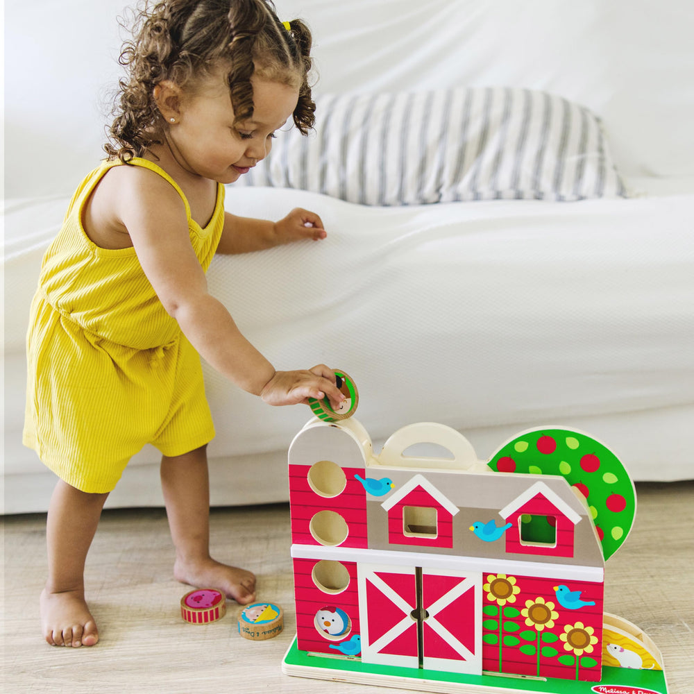 Melissa & Doug GO Tots wooden barn with silo invites tactile exploration.