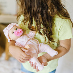 Jenna pacifier-sucking feature enhances caregiving pretend play.