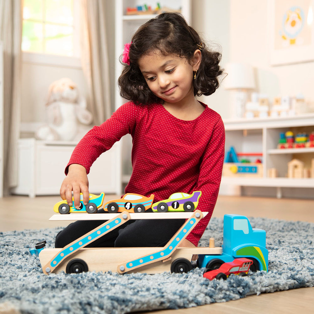Melissa & Doug Mega Race-Car Carrier features colorful designs that invite sorting by color and pattern.