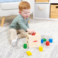 Lid-open Melissa & Doug cube showing shapes for easy grasp and motor practice.