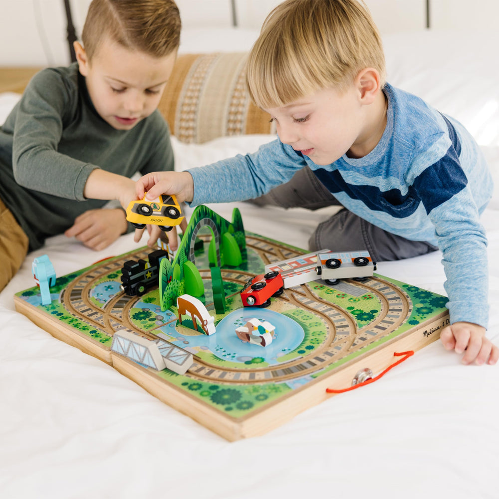 Melissa & Doug Take-Along Railroad built-in tracks invite kids to connect pieces for tactile play.