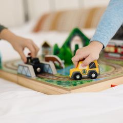 Melissa & Doug Take-Along Railroad scenic play surface supports various narratives.