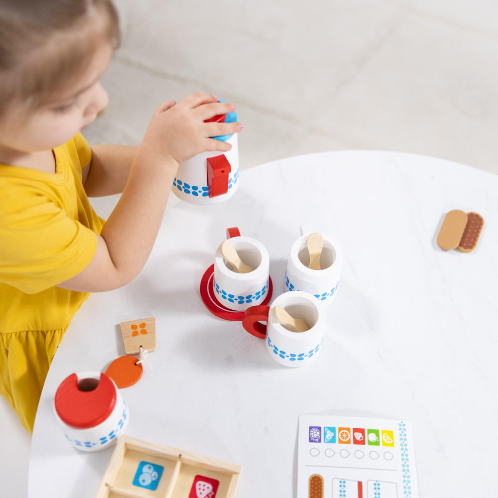 Melissa and Doug tea set cups and spoons arranged for two guests