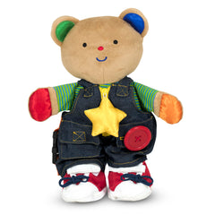 Melissa & Doug Teddy Wear bear with removable outfit for dressing and fine motor practice.
