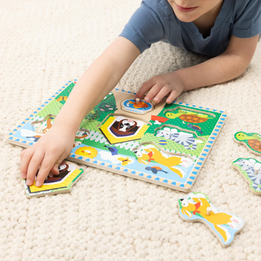 A child solving a Melissa & Doug peg puzzle demonstrates focused play