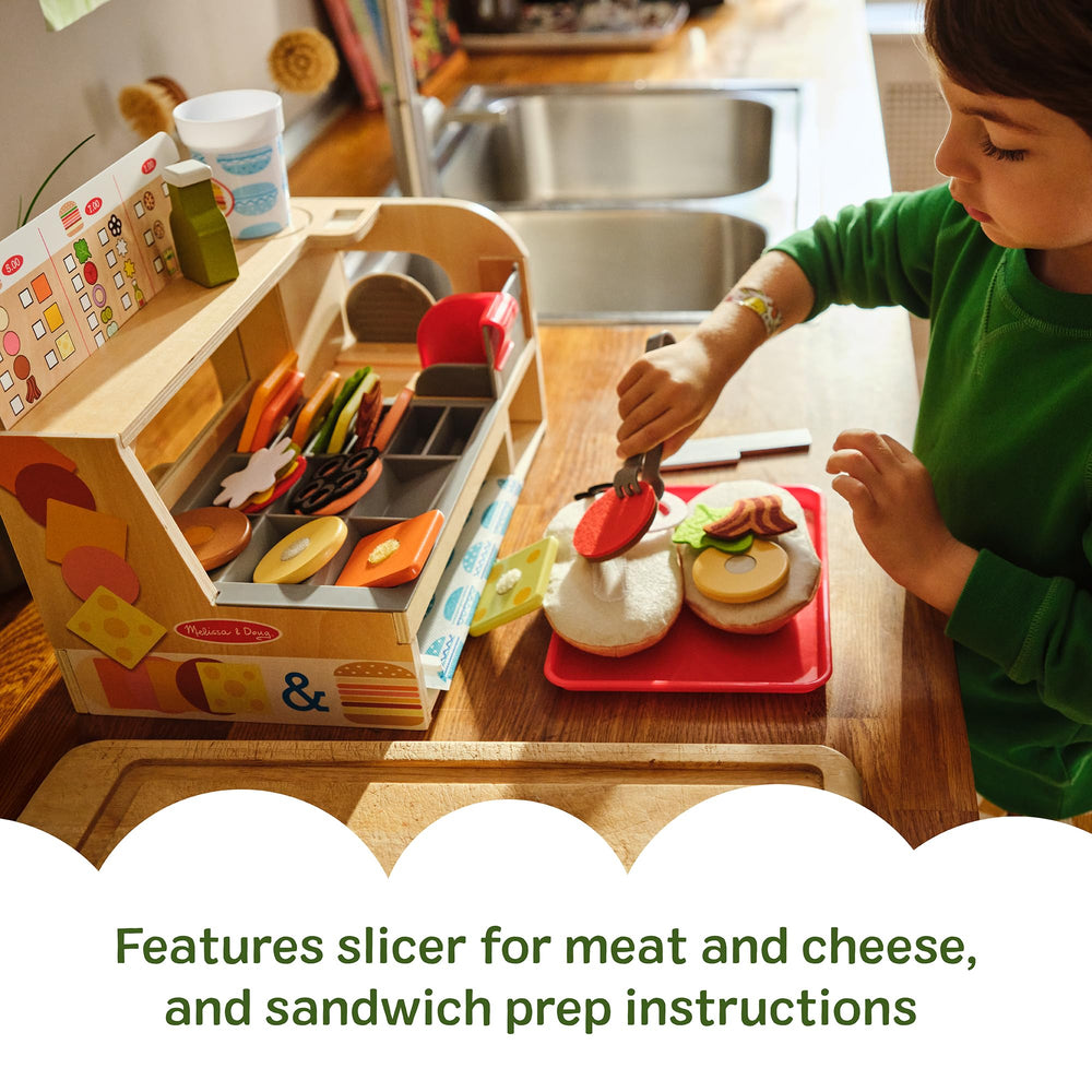 Melissa & Doug counter displays the slicer and prep area for sandwich assembly.