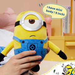 MINISO Stuart plush resting against a backpack demonstrates travel-friendly companion.