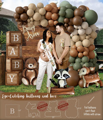Monnberry woodland balloon garland creates a festive arch for photos