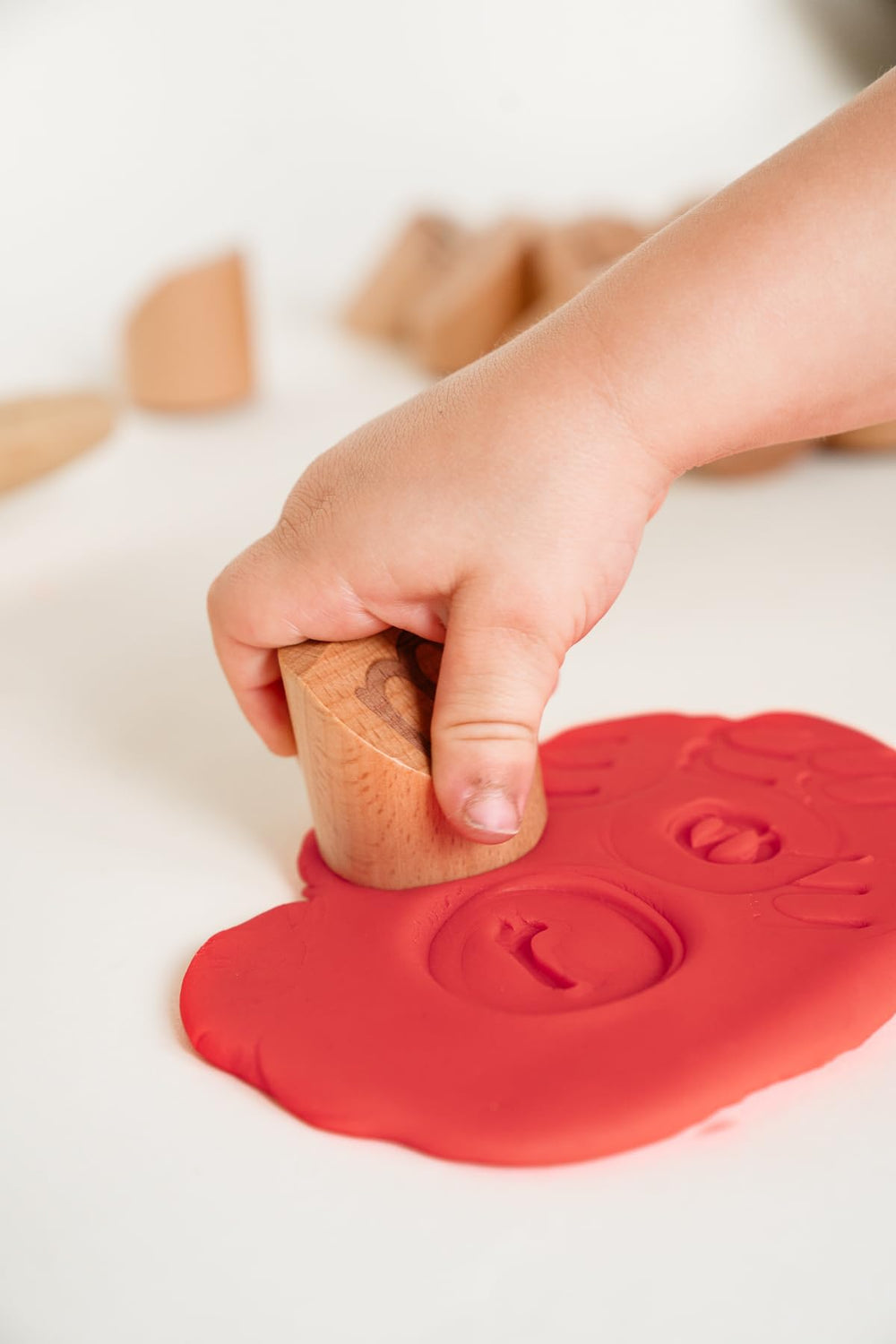 Montessori & Me Alphabet Stamps help refine motor skills through stamping clay.