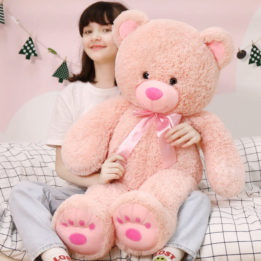 MorisMos pink teddy bear with stitched footprints adds charm.