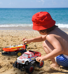 Mozlly beach-adventure setup invites shore-side imagining with truck and boat.