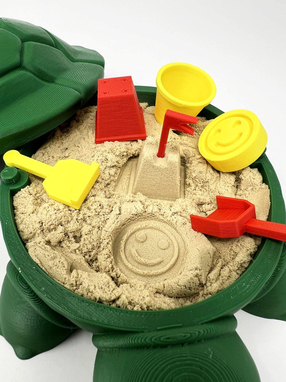 MunnyGrubbers turtle sand box interior with storage notch for organized desk play.