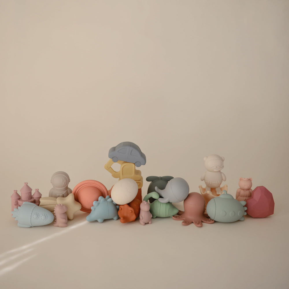 Mushie Dino Bath Toy opens into two pieces for easy cleaning.
